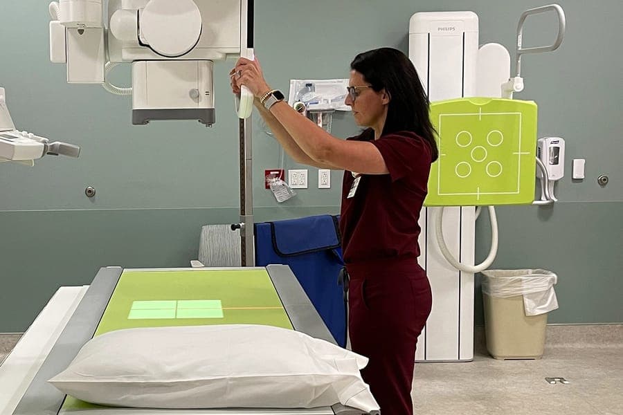 A technician works with the x-ray machine
