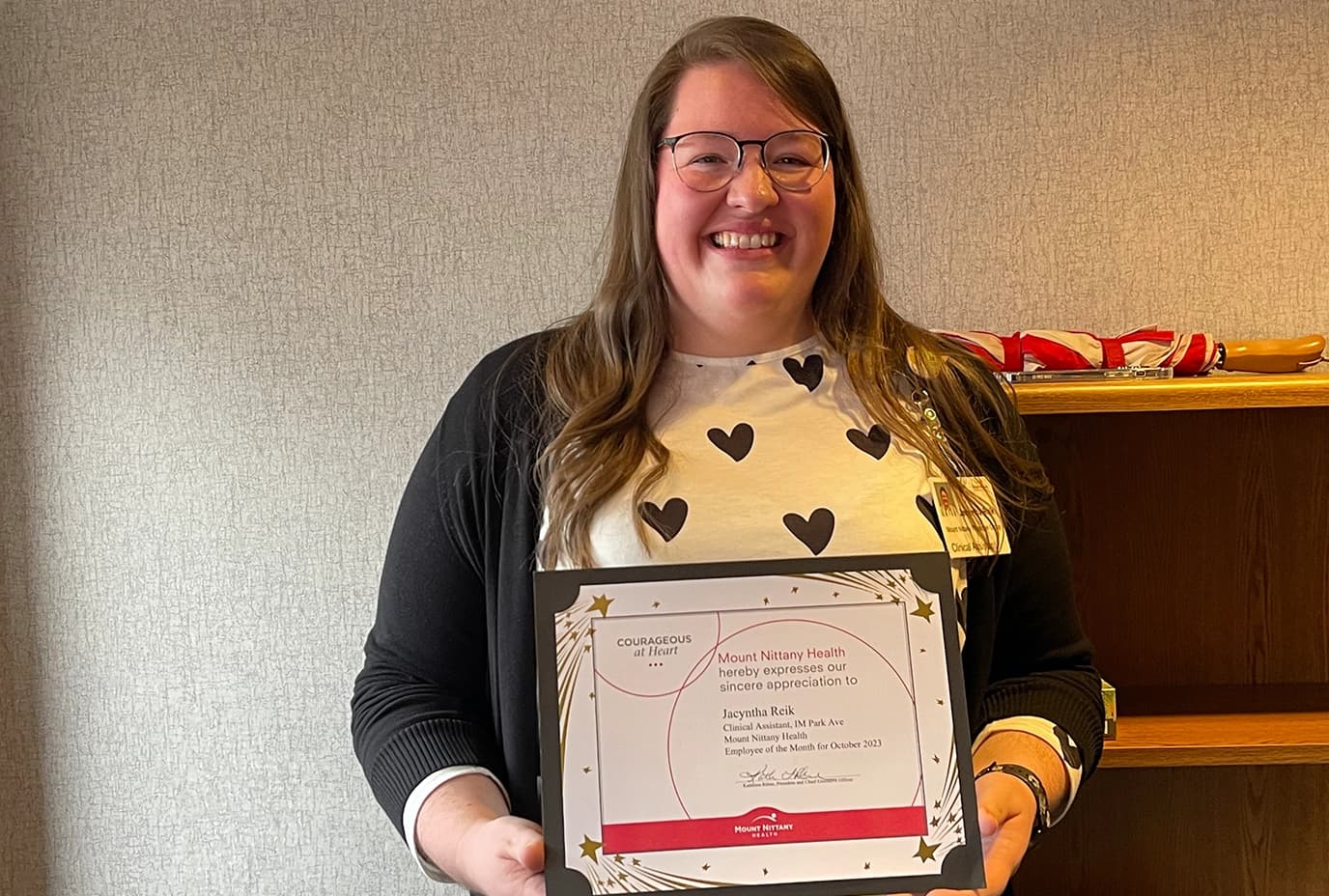 Jacyntha Reik poses with her employee of the month certificate